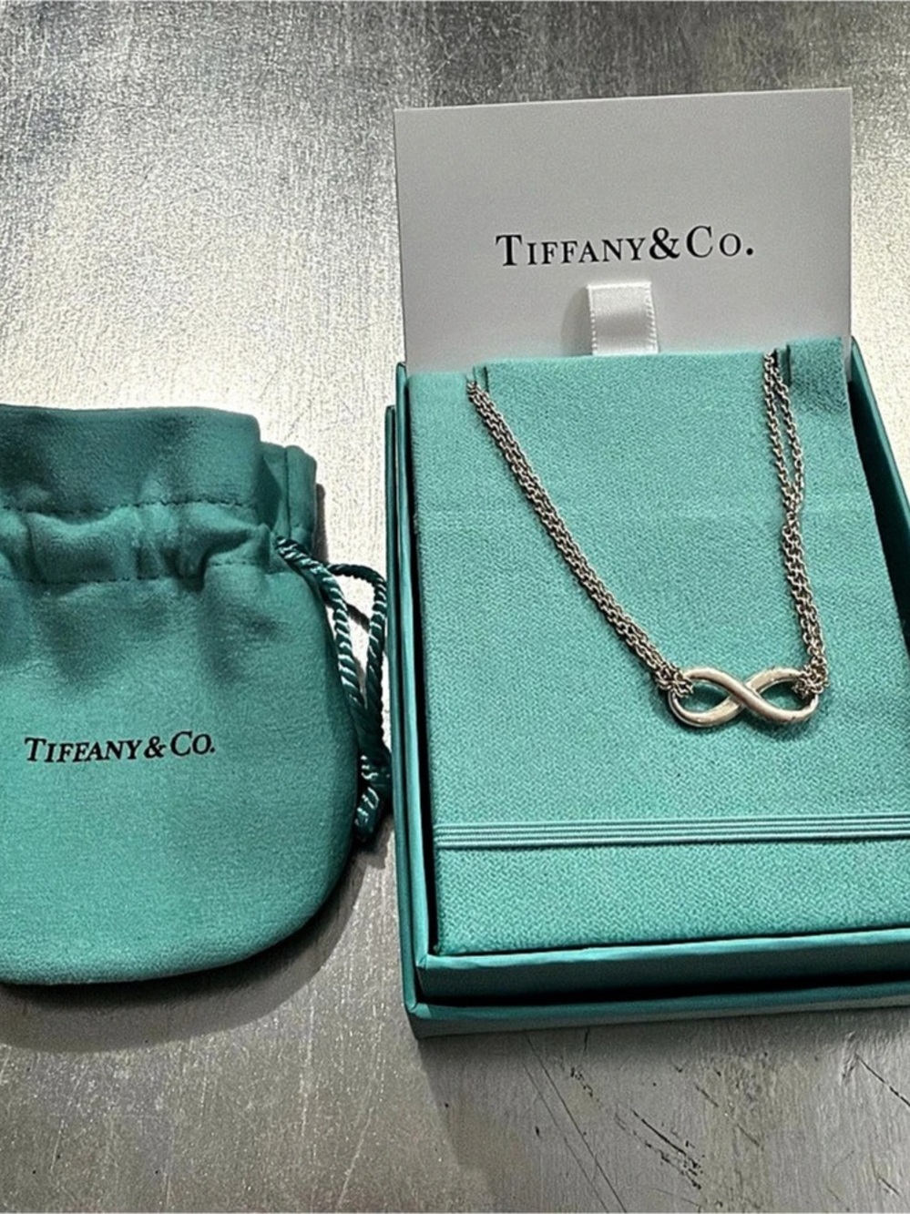 Tiffany & Co. Silver Infinity Pendant on a Double Chain.